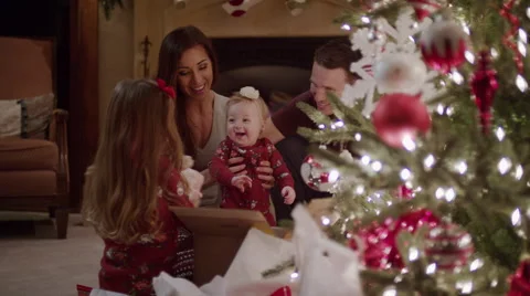 Medium shot of family opening Christmas presents / Cedar Hills, Utah, United Stock Footage