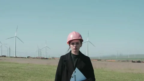 Medium shot of female engineer standing in the middle of the windmill Stock Footage 238009062