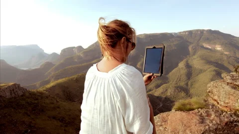 Medium shot of Female working on touch screen tablet computer with epic beautifu Stock Footage 199615750