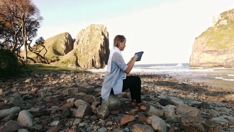Medium shot of Female working on touch screen tablet computer with epic beautifu Stock Footage 199617173