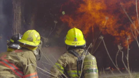 Medium shot of firefighters and flames Stock Footage 61177828