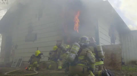 Medium shot of firemen spraying fire Stock Footage 60753380