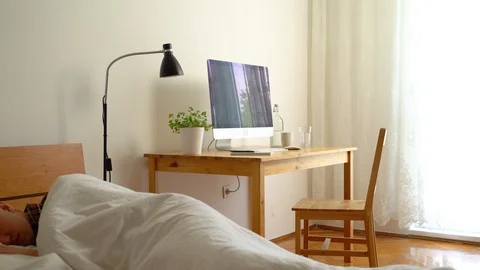 Medium shot of frustrated man waking up late for working from home Stock Footage 128770766