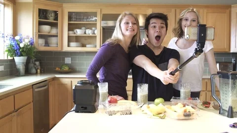 Medium shot of group of friends taking selfie while drinking juice Stock Footage 76537701