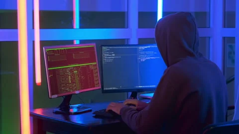 Medium shot of hacker dressed in a dark close working on computer. Stock Footage 155808654
