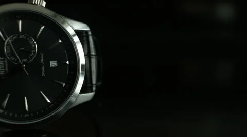 Medium shot of a half faced Black Wrist Watch against dark background Vídeo Stock 68191715