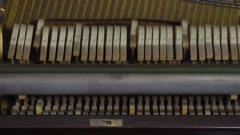 MEDIUM SHOT OF HAMMERS HITTING STRINGS IN AN UPRIGHT PIANO Stock Footage 126418208