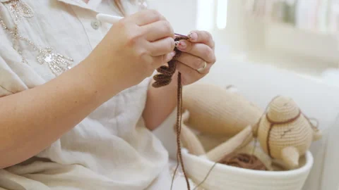 Medium shot, hand crocheting a handmade doll with yarn Stock Footage 344092145