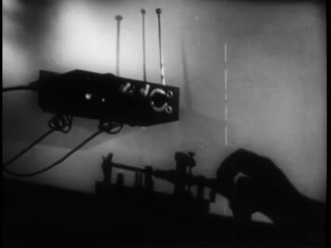 Medium shot of hand sending morse code message through shortwave transmitter Stock Footage 260248860