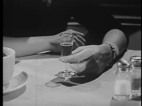 Medium shot of hand on table fidgeting with glass 스톡 동영상 260251632