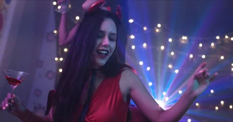 Medium Shot, Handheld – A beautiful lady enjoying a Halloween party with friend. Stock Footage 139855840