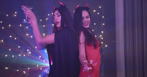 Medium Shot, Handheld - Two female friends dancing at a Halloween costume party. Stock Footage 139854143