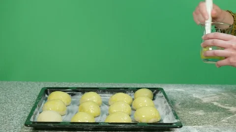 Medium shot of hands of woman while decorate sweets by coloring them yellow w Stock Footage 126611637