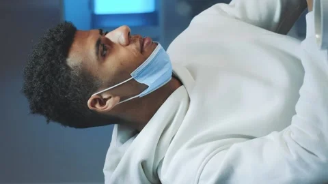 Medium shot of Handsome black man with medical mask smiling to the camera while Stock Footage 131531341