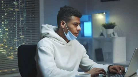 Medium shot of Handsome black man with medical mask smiling to the camera while Stock Footage 131535264