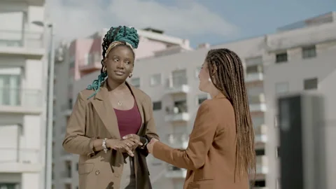 Medium shot of happy executives standing on rooftop and talking Stock Footage 167412524