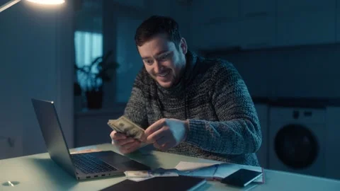 Medium Shot Happy Man Counting Dollars Celebrating Laptop Success Stock Footage 333270727