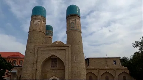 Medium shot of historic Chor Minor madrasah with blue domes in Bukhara Stock Footage 335945220