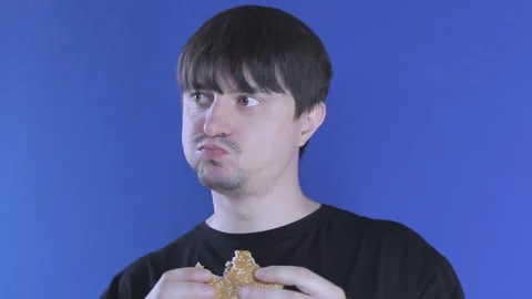 Medium shot hungry guy eats a burger greedily. Unhealthy food Stock-Footage 137970820