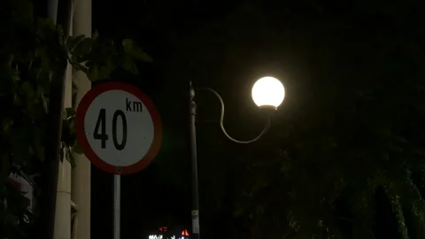 Medium shot, Indonesian speed limit 40 km/h road sign at night Stock Footage 139547658