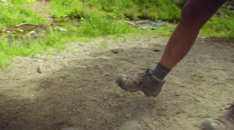 Medium shot of legs and feet crossing stream Stock Footage 59081759