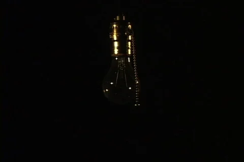 Medium shot of light bulb turned on Stock Footage