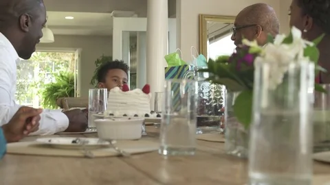 Medium shot of little boy opening a birthday card Video stock 76233801