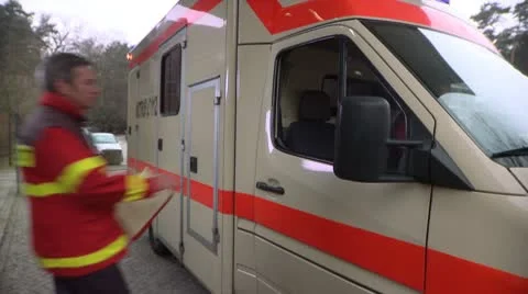 Medium Shot, Lockdown, Paramedic getting into an ambulance Stock Footage 10701376