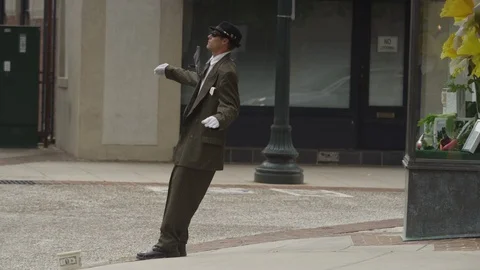 Medium shot of magician performing tricks on the city pavement Stock Footage 103430339