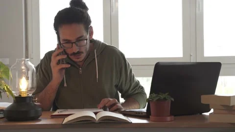 Medium shot of male on the phone while working from home Stock Footage 162107235