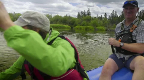 Medium shot of man and woman on raft Stock Footage 59708180