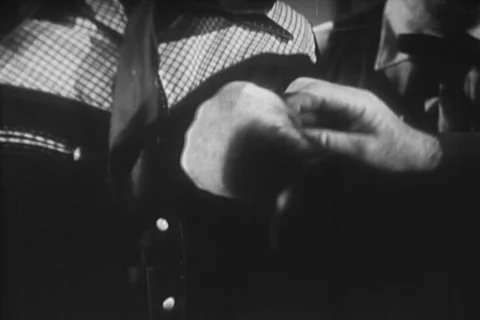 Medium shot man attaching sheriff badge to cowboy's shirt, 1940s Stock Footage 95347886