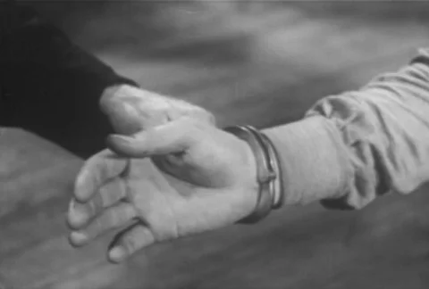 Medium shot of man being handcuffed, 1930s Stock-Footage 95997039