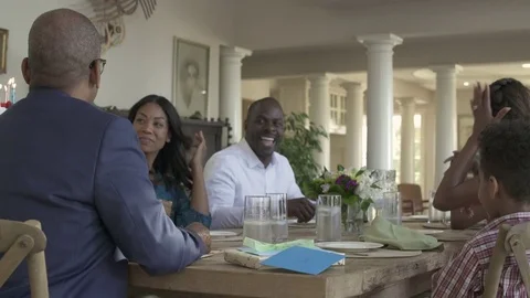 Medium shot of man blowing out birthday candles Stock Footage 76233613