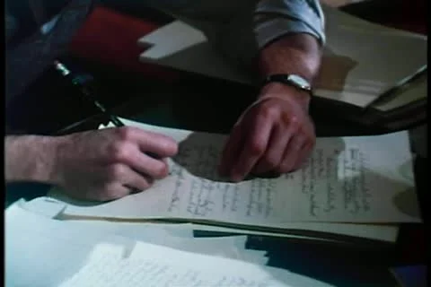 Medium shot of man briskly writing on paper with pencil Видео 11366074