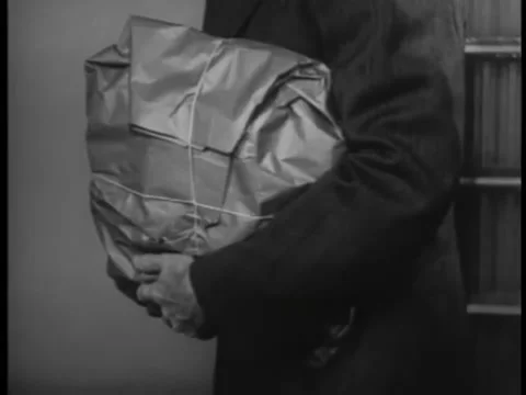 Medium shot of man carrying parcel tied with string Video stock 260256845