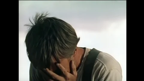 Medium shot of man covering his face and crying, 1950s Vídeos de archivo 95997151