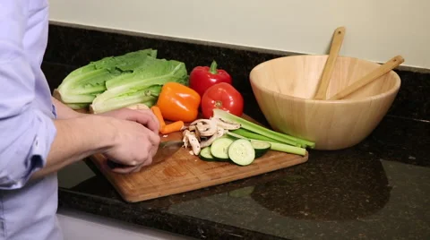 Medium shot of man cutting carrots Stock Footage 61403335