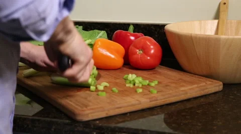 Medium shot of man cutting celery stalks Stock Footage 61403261