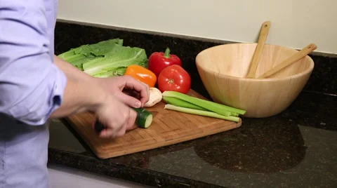 Medium shot of man cutting cucumber Stock Footage 61403381