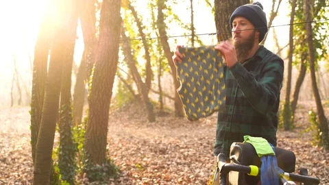 Medium shot of man hanging clothes while camping during winter, Croatia. Stock Footage 127219365