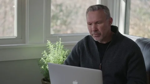 Medium shot of man at laptop Stock Footage 70810164