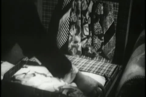 Medium shot of man packing suitcase Stock Footage