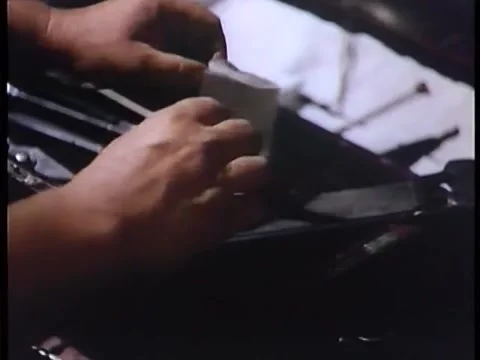 Medium shot of man picking up folded note which says KILL HIM Stock Footage 58858751