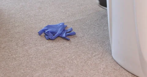 Medium shot man picking gloves up off of the floor 動画素材 130671782