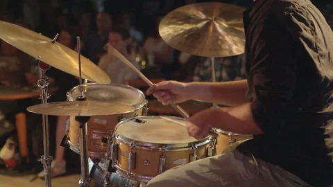 Medium Shot Off Man Playing On His Drum Kit With An Audiance In The Background Video stock 126700847