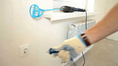 Medium shot Man plug drill into the socket 動画素材 65287874