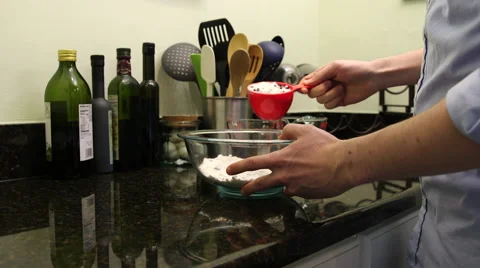 Medium shot of man pouring flour mix into bowl Stock Footage 61401125