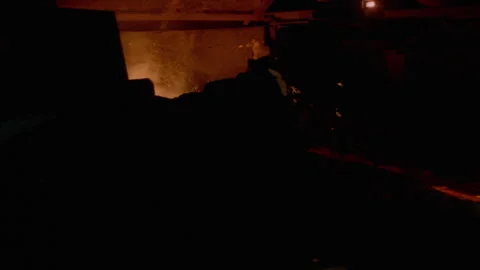 Medium shot of a man in protective gear working near a furnace Stock Footage 312274035