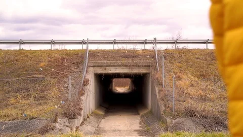 Medium shot of man pushing a bicycle inside of a tunnel, Croatia. Video stock 127220238